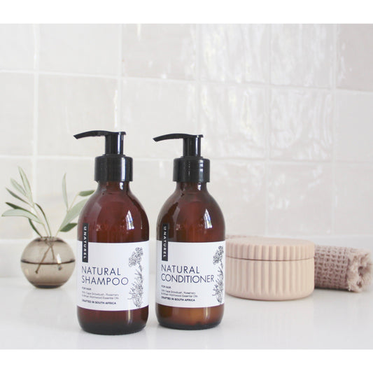 Le Naturel Natural Shampoo & Conditioner Set beside a bath