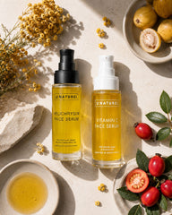 Two 'Unaturel' face serum bottles on a textured surface with natural elements.